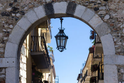 Low angle view of street light against building