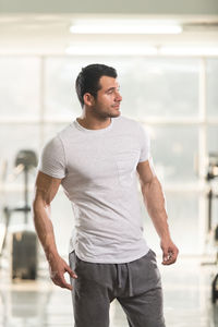 Muscular man standing in gym