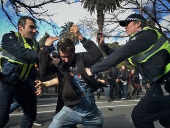 Young men standing against sky