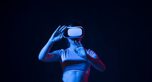 Close-up of woman against black background