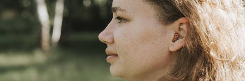 Close-up portrait of young woman looking away