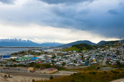 Town by mountains against sky