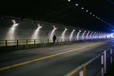 Man on illuminated road