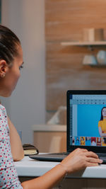 Young woman using laptop at office