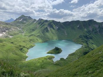 High angle view of lake amidst mountains against sky