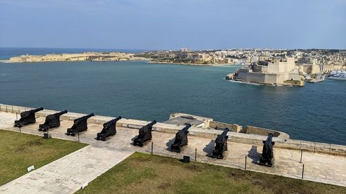 High angle view of sea by city against sky