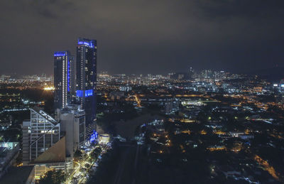 High angle view of illuminated buildings in city at night
