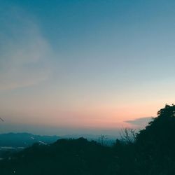 Scenic view of silhouette mountains against sky at sunset