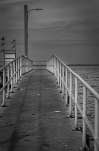 Pier over sea against sky