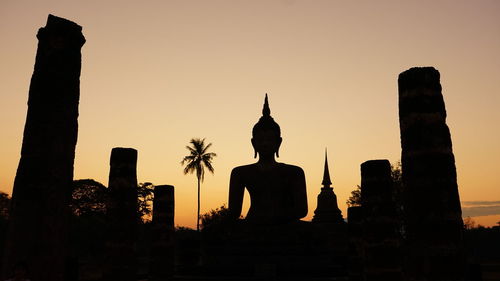 Silhouette temple against sky during sunset