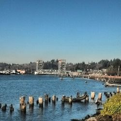 Scenic view of river against clear blue sky