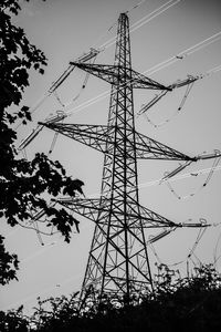 Low angle view of electricity pylon against sky