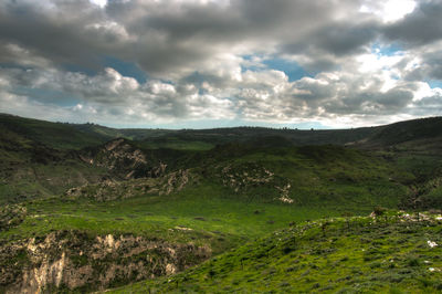 Scenic view of landscape and mountains against sky