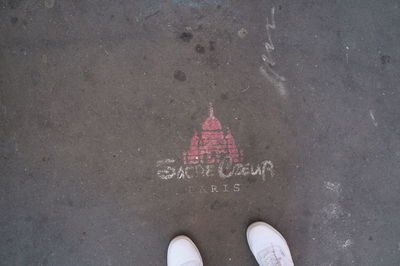 Low section of man standing on tiled floor