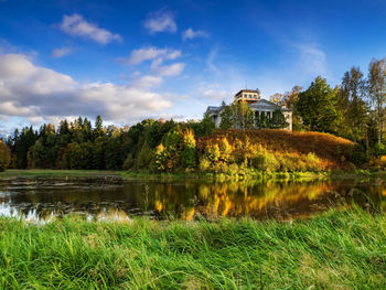 Scenic view of lake by building against sky