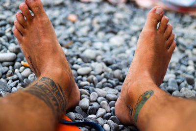 Low section of man legs on pebbles
