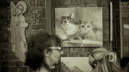 Portrait of woman with cat seen through glass