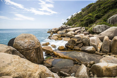 Rocks on beach against sky