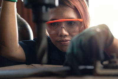 Close-up of woman working in factory