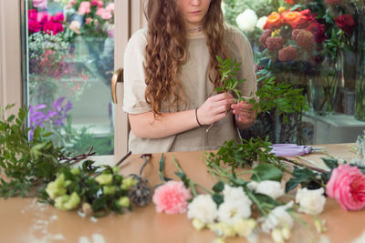 Midsection of florist working in flower shop