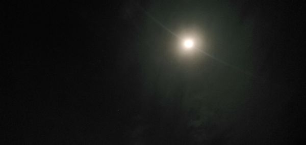 Low angle view of moon in sky at night