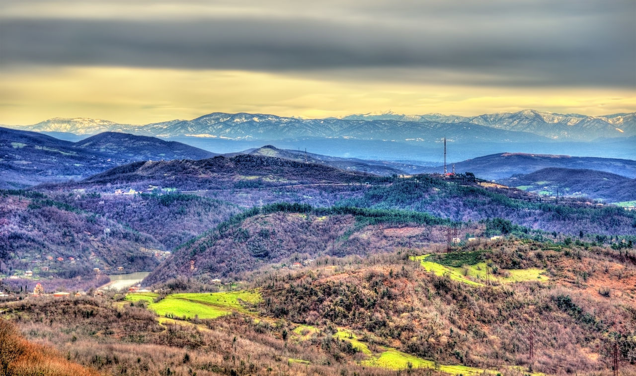 SCENIC VIEW OF LANDSCAPE AND MOUNTAINS AGAINST SKY