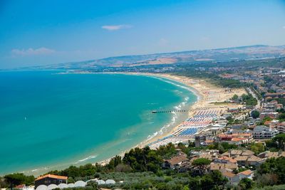 High angle view of sea and city against sky