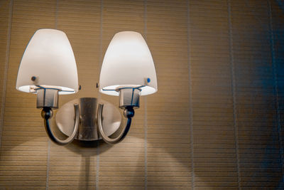 Close-up of electric lamp on wall