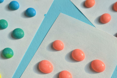 Macro close-up of old fashioned button candy on strips of white paper