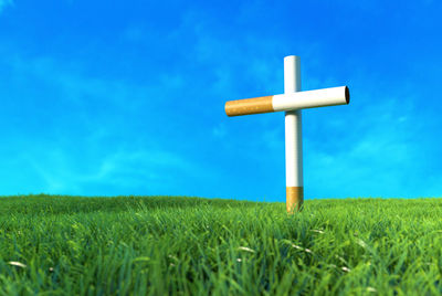 Wind turbines on field against blue sky