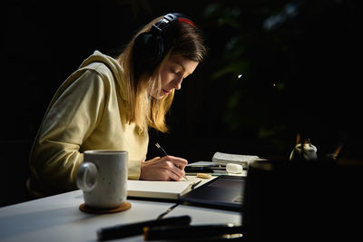 Female designer working in home office at night