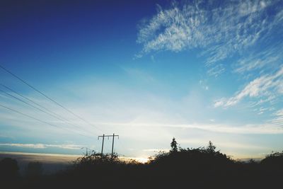 Low angle view of electricity pylon against sky