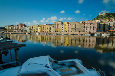 Reflection of buildings in canal against sky