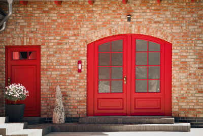 Red door on brick wall of building