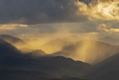 Scenic view of mountains against dramatic sky