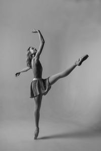 Ballet dancing against gray background