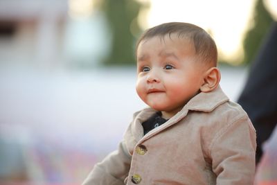 Portrait of cute baby girl looking away