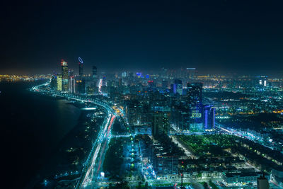 High angle view of illuminated buildings in city at night