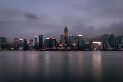 Illuminated buildings in city at dusk