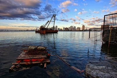 Boats in harbor at sunset