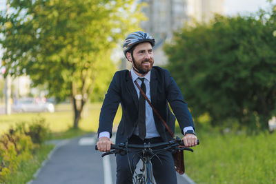 Portrait of young woman standing on road