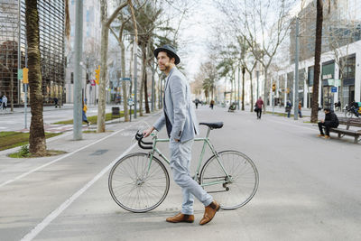 Portrait of man riding bicycle on street in city