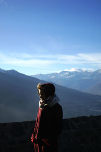 Woman looking at mountain against sky