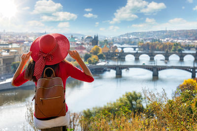 Rear view of woman standing against city