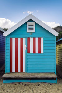 Beach hut against blue sky