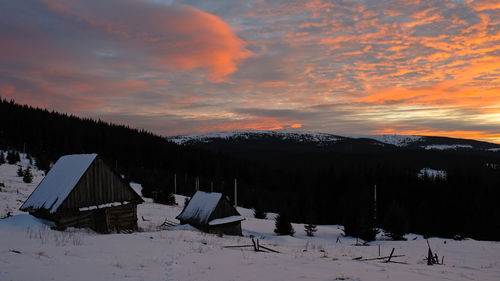 Scenic view of snow covered landscape against sky during sunset