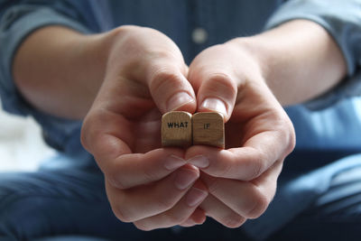 Midsection of man holding text