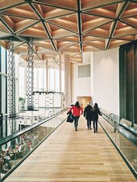 Rear view of people walking in corridor