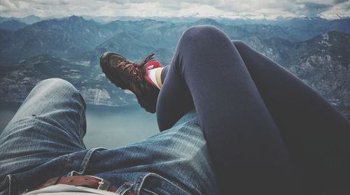 Couple lying against mountains