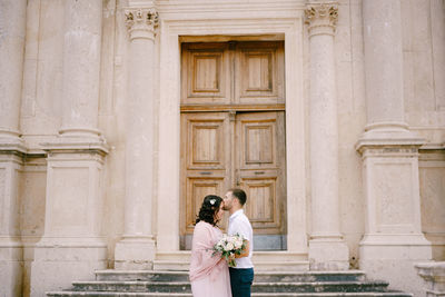 Full length of couple standing at historical building